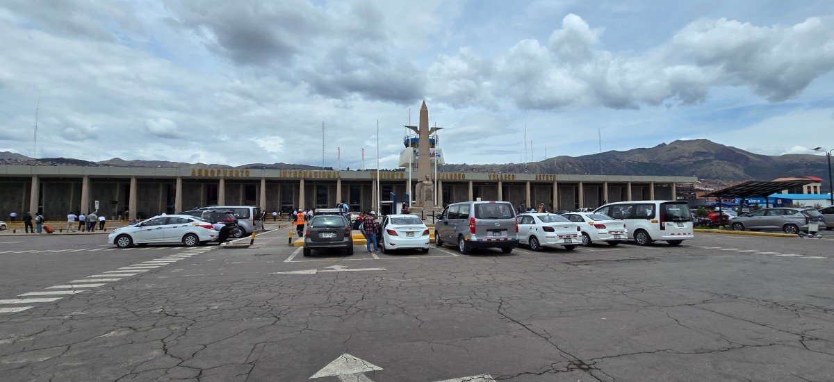 Vehicle waiting at Cusco airport with driver holding a name sign.